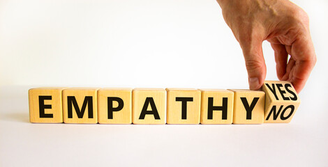 Empathy yes or no symbol. Psychologist turns wooden cubes and changes words empathy no to empathy...
