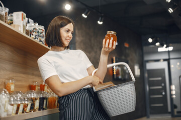 Beautiful woman in the store buys groceries.