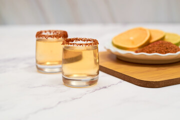 Mexican mezcal shot with chili pepper and orange.