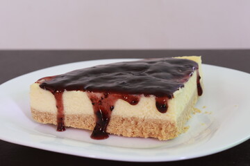 A piece of cheese cake with blackberry cream
