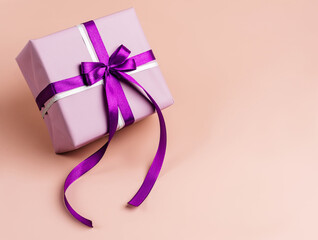 Lavender gift or present box with velvet, violet bow on beige background. Empty space for text on the right side.