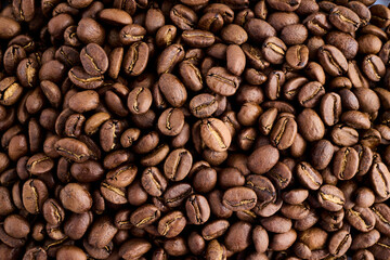 Closeup of dark coffee arabica beans texture. Caffeine aroma. Pile of scented black grains