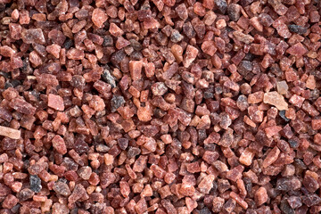 Natural red mideral stones and rocks granite ground background horizontal closeup