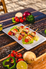 Colorful Food Appetizer Starts Snacks Fresh Delicious Menu Recipe Meal Meat Chicken Fries Fish Seafood Beer on a wooden table on the Beach