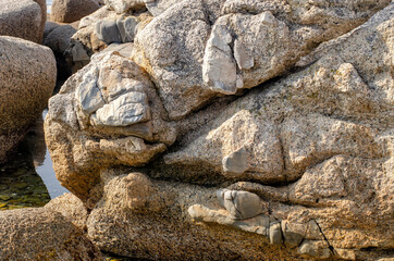 Fototapeta na wymiar Lumps of granite crystal structure close up.