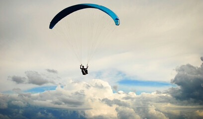 Man paragliding in the sky and beautiful clouds 