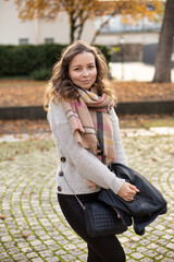 European white young woman with brown hair walking in autumn