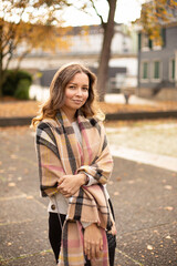 Pretty european white young woman with brown hair walking in autumn