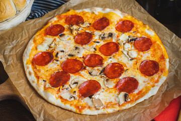Traditional Italian pizza pepperoni with cheese and mushrooms.