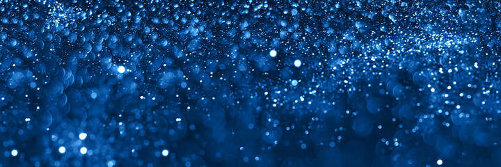 Blue sparkling glitter bokeh background, christmas texture. Holiday lights. Abstract defocused header. Wide screen wallpaper. Panoramic web banner with copy space for design