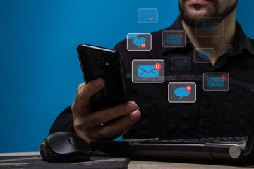 Social media notification. The man uses the phone to work on social networks. Freelance concept