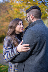 Fototapeta premium Embracing white young european man and woman with dark hair portrait