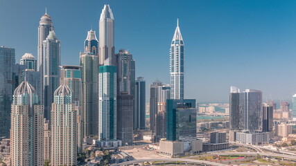 Fototapeta na wymiar Skyscrapers of Dubai Marina near intersection on Sheikh Zayed Road with highest residential buildings timelapse