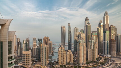 Fototapeta na wymiar Skyscrapers of Dubai Marina near Sheikh Zayed Road with highest residential buildings morning timelapse