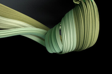 Green color strip wave paper on black. Abstract texture background.