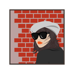 a girl in a beret and glasses on the background of a brick wall