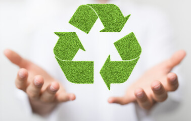 hand holding green recycle symbol