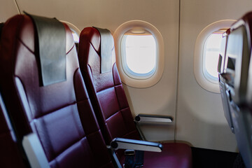 empty red seats for passengers in the cabin of the aircraft. Economy class. 