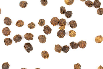 Lot of whole spicy black pepper isolated on white background randomly placed