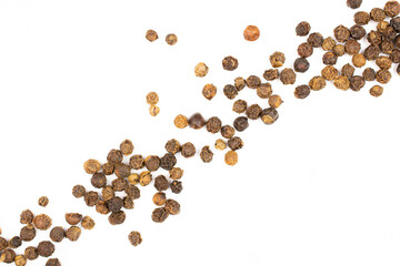 Lot of whole spicy black pepper isolated on white background placed diagonally