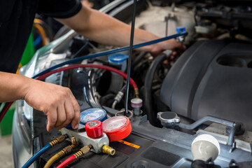 Auto mechanic monitor to check and fixed car air conditioner system in car garage. service car air...