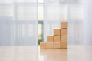Businessman arrange wooden blocks stacked in uneven steps like obstacles, business growth journey...