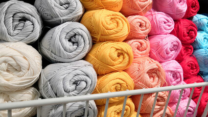 Rolls of colored yarn lying on top of each other