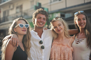 portrait of group of smiling young people in the street