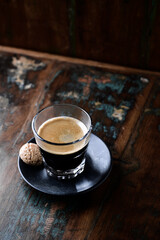 Coffee in glass cup on rustic wooden background. Copy space.	