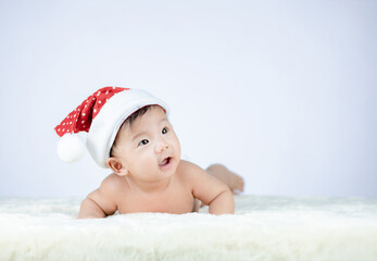 Christmas portrait of cute little Baby wearing santa hat.