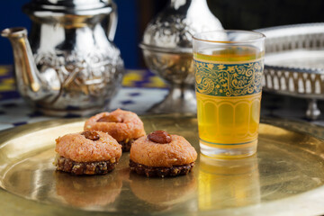 Moroccan almond pastries with mint tea on a golden tray