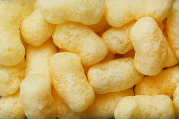 Corn sticks in powdered sugar as a texture, crispy sweets