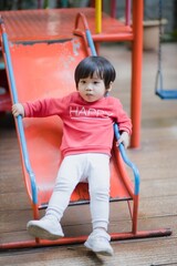 Child playing on outdoor playground.