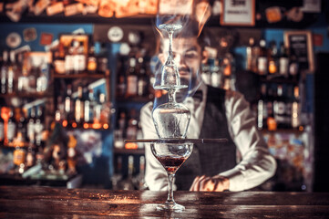 Expert bartending demonstrates his skills over the counter at the night club