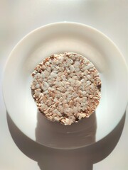buckwheat diet round bread on a white plate on a white background