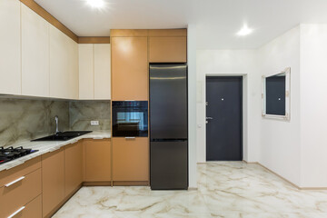 interior of a large kitchen with orange in a modern style