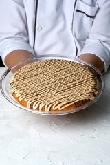 Traditional Arabian sweets with Cream and Cheese with pistachio nuts and flavor on top on gray background