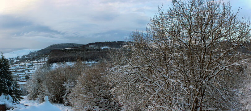 Scenic snow-covered trees and view towards Pontypool in the Welsh Valleys