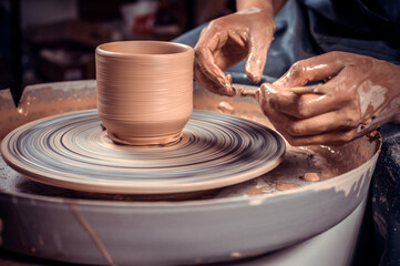 Potter craftsman working with pottery at the ceramic workshop. Inspiration and creativity. Close-up.