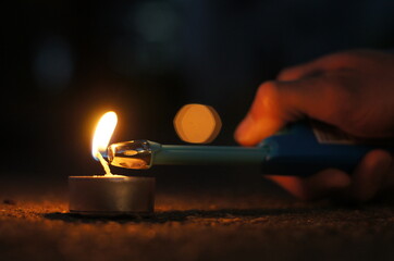 Mała świeczka która podczas zapalania jej i pojawienia się płomienia dającego światło na...