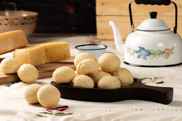 Cheese bread, breakfast table in Brazil, cheese bread, coffee and accessories, selective focus.