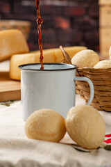 Cheese bread, breakfast table in Brazil, cheese bread, coffee and accessories, selective focus.