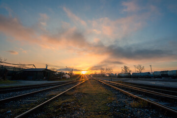 Fototapeta na wymiar Two railways lit in sunrise colors