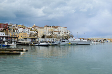 Fototapeta na wymiar Termoli - Molise -The houses overlooking the harbor and the small boats in the foreground