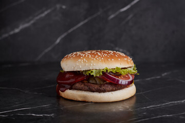 burger with meat and cheese on the table, american cuisine, close-up, tomato, dark background, marble,