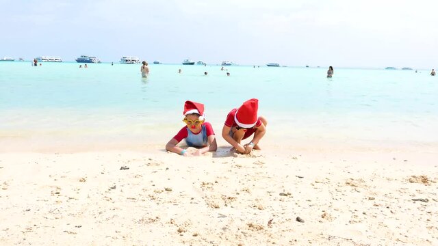 funny Christmas boys in Santa hats enjoy vacation