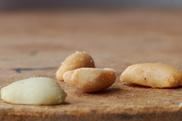 Fototapeta na wymiar macro photo of nuts on a wooden table, peanuts, beer snacks, blurred background