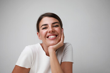Portrait of happy young caucasian woman, smilling posing over white background.