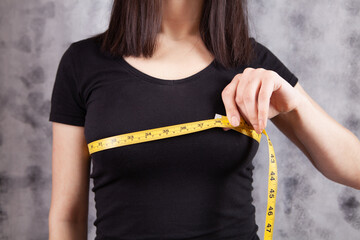 young girl measures her breasts