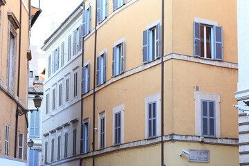 Fototapeta na wymiar Traditional Building Facades with Windows with Shutters in Rome, Italy
